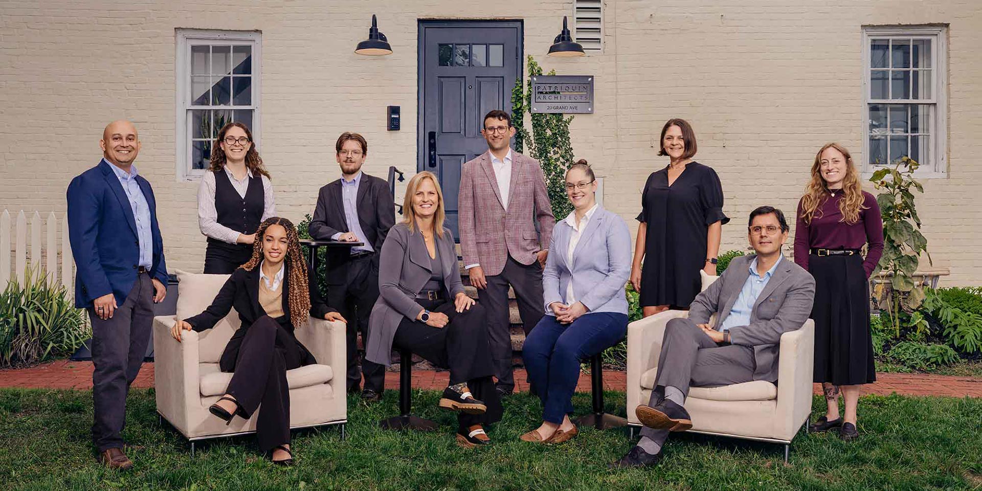 The Patriquin Architects team, standing on the grass behind our office in New Haven